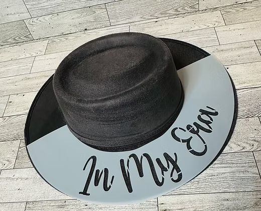 Black boater hat with "In My Era" etched on the brim.