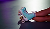 woman wearing blue roller skates with pink wheels