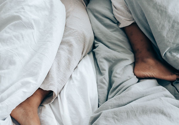 a person trying to sleep with restless leg syndrome