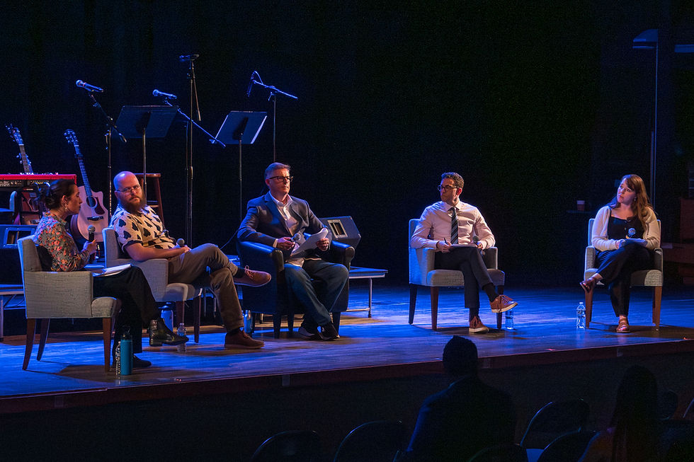 Four people sitting in a discussion panel