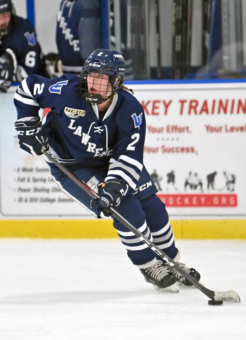Female Hockey player skating on ice