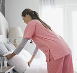 Home Nurse Making Bed