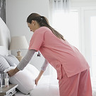 Home Nurse Making Bed