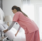 Home Nurse Making Bed