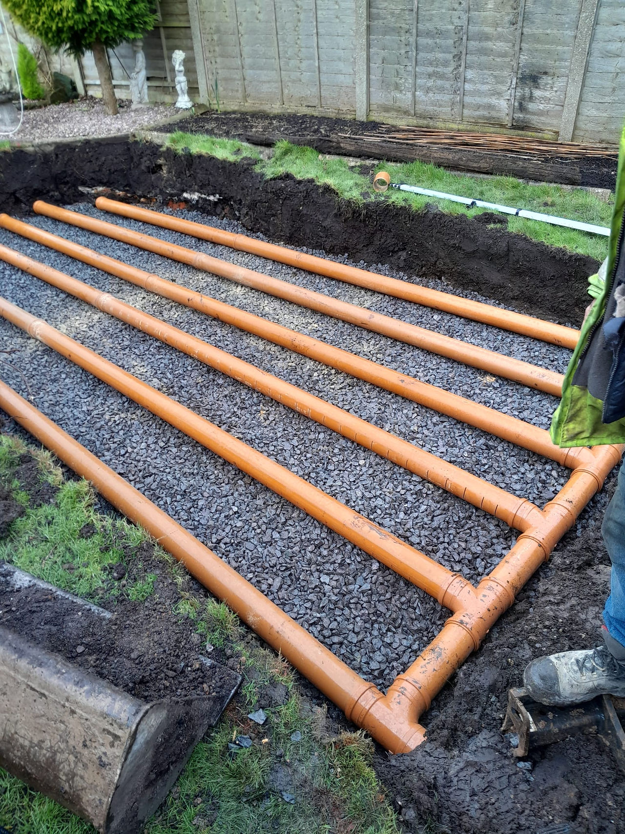 side view of soakaway gravel base with soakaway pipes laid over the top