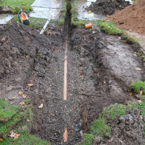 pipes and trenches for soakaway being infilled