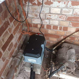 image showing new waste pump situated on a small concrete plinth inside a brick built outbuilding