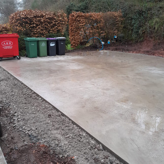 a well laid concrete garage base with surrounding hardcore