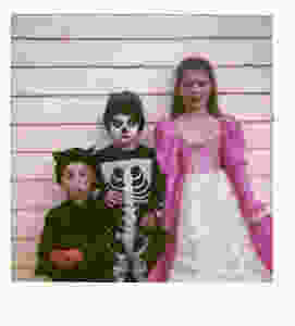 three young children in Halloween costumes