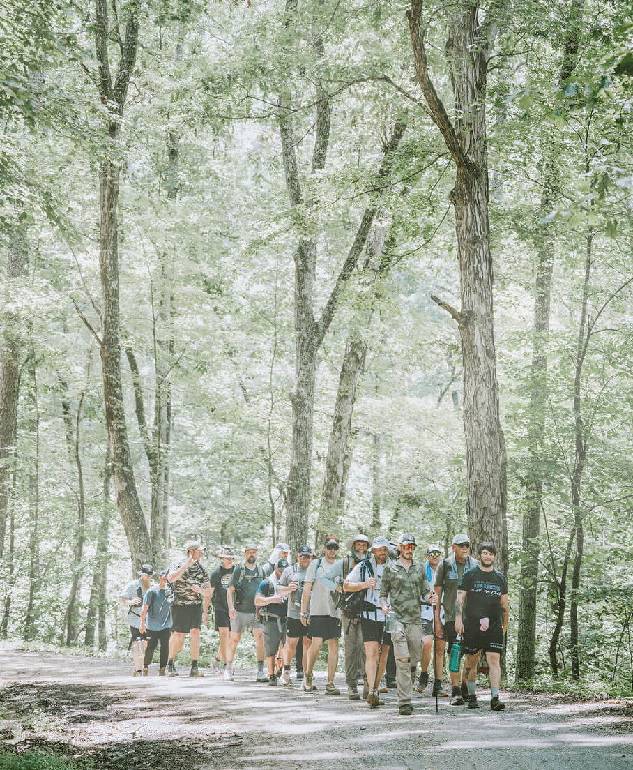 ROP Team making their way along a forest trail during Rite of Passage outdoor training