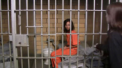 Female_prisoner_shackled_in_her_small_cell