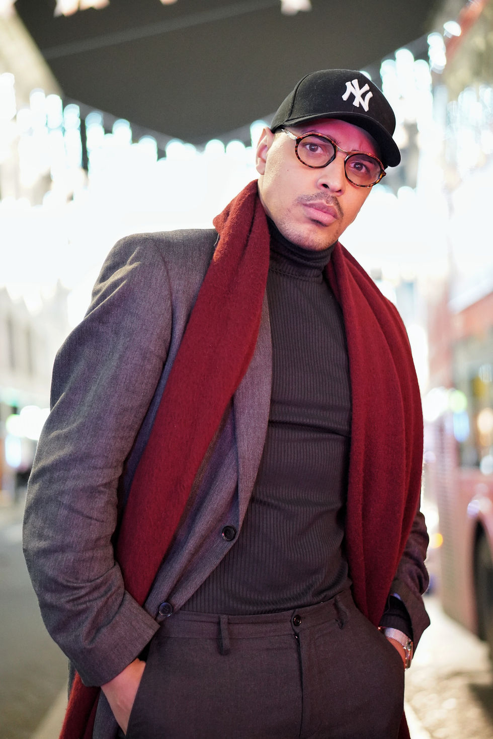 Man in suit and scarf at night