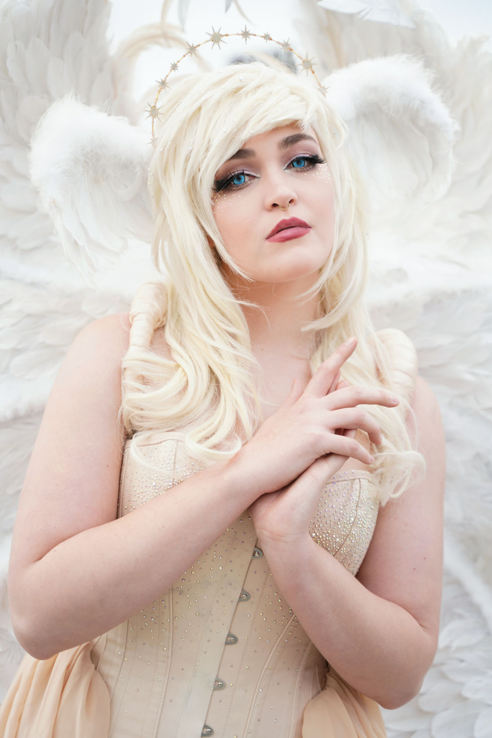 Serene blonde woman in angel anime costume