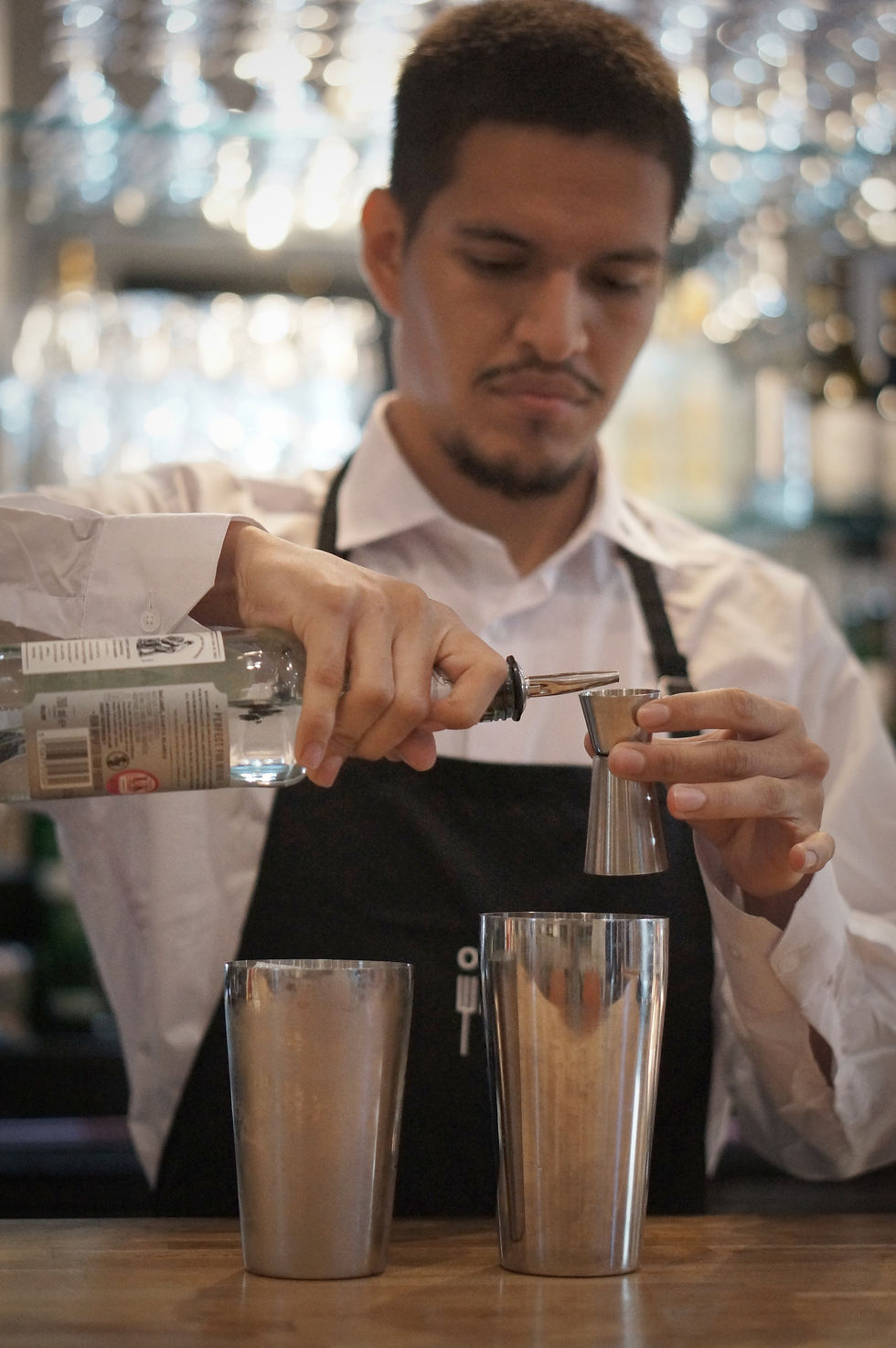Bartender meticulously crafting cocktail