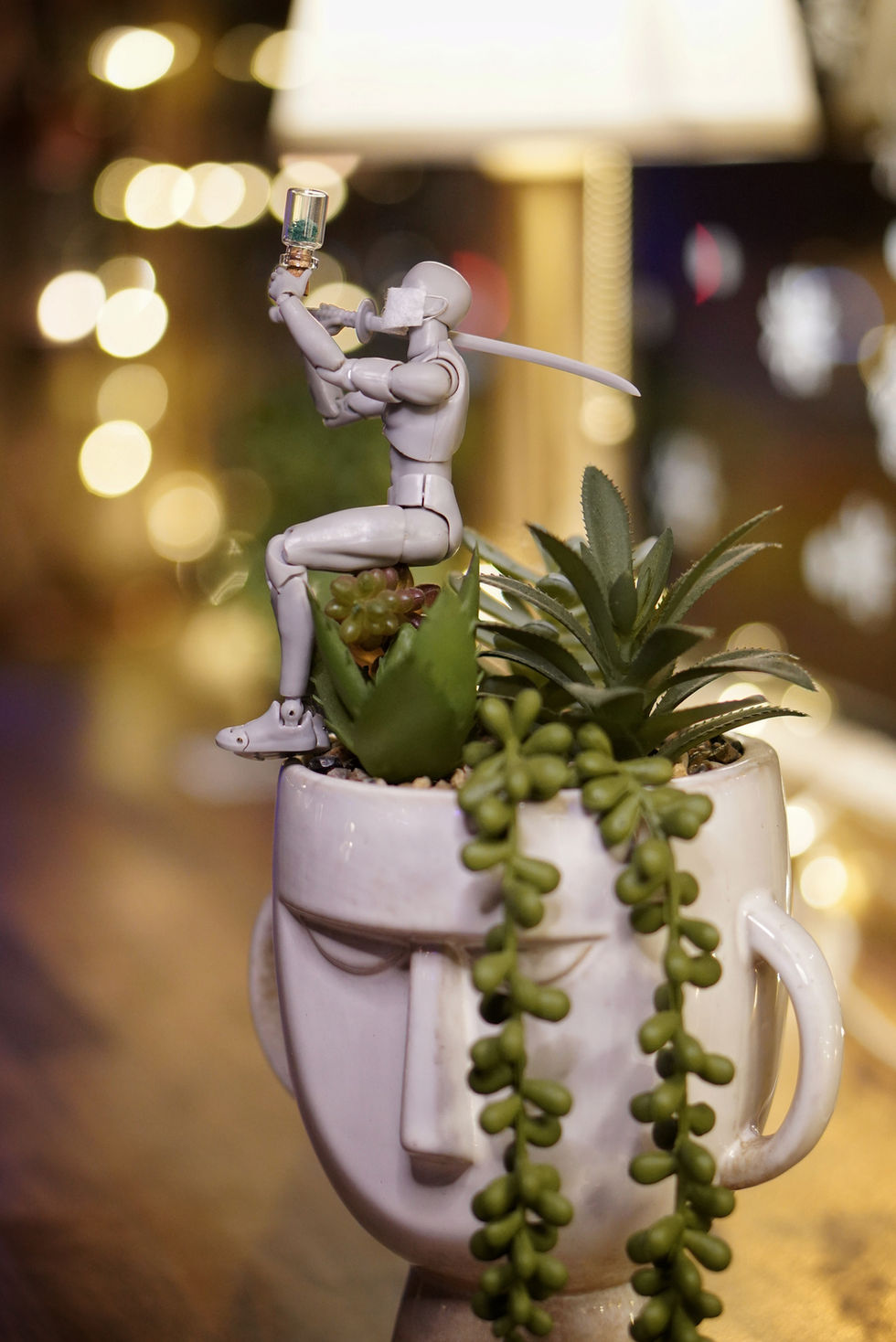 Robot figurine enjoys ice cream on succulent planter