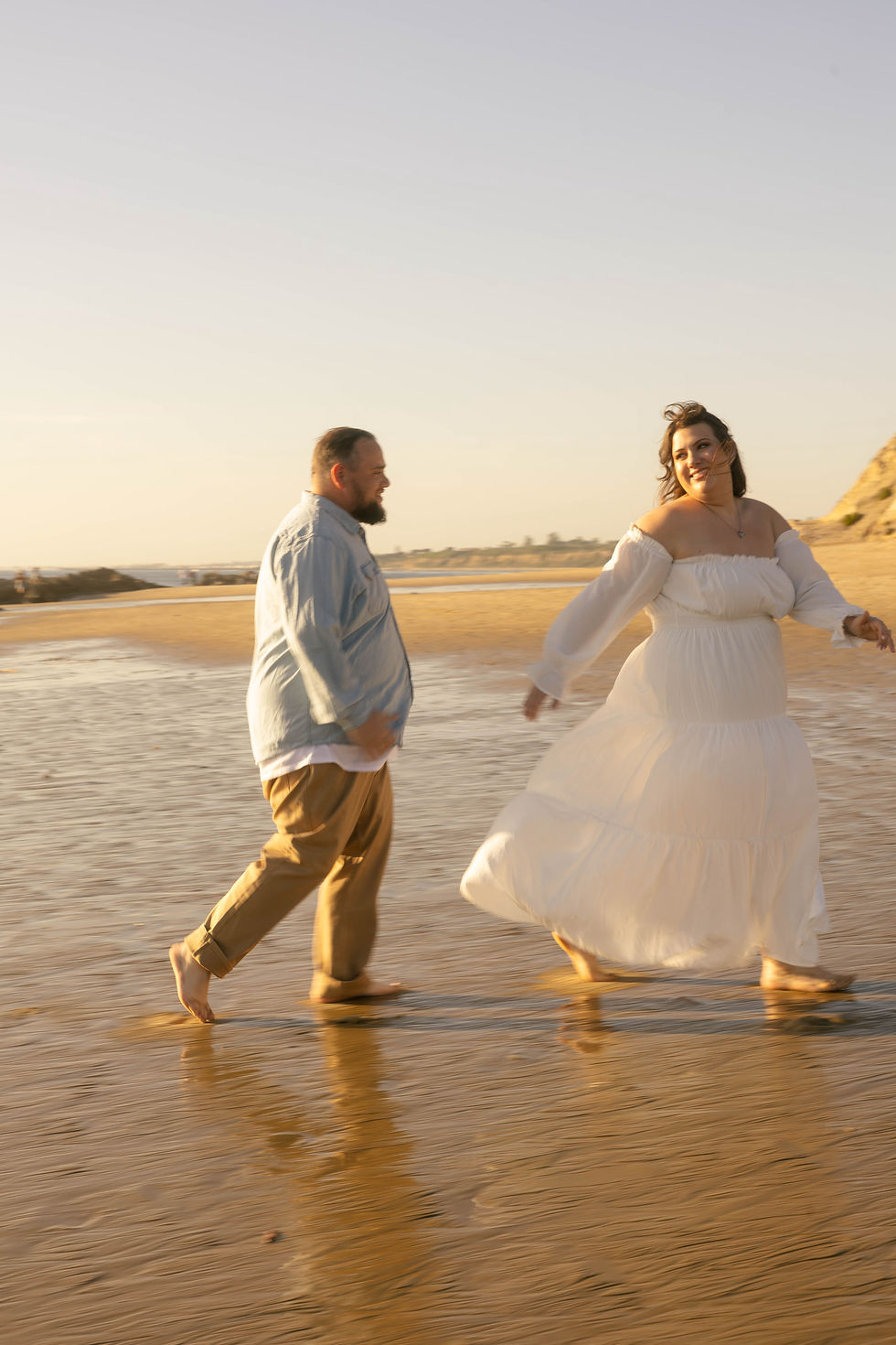Wide angle view of a vineyard wedding venue with golden hour sunlight