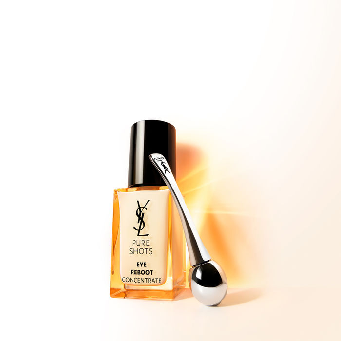 YSL Pure Shots Eye Reboot amber bottle with silver applicator on light background, by Clement Halborn.