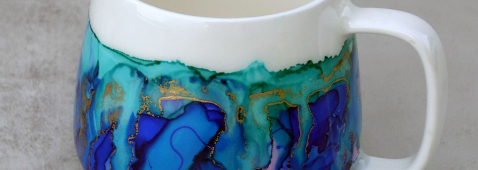 Hand painted with alcohol ink mug in blue and teal with markings. 16 ounces