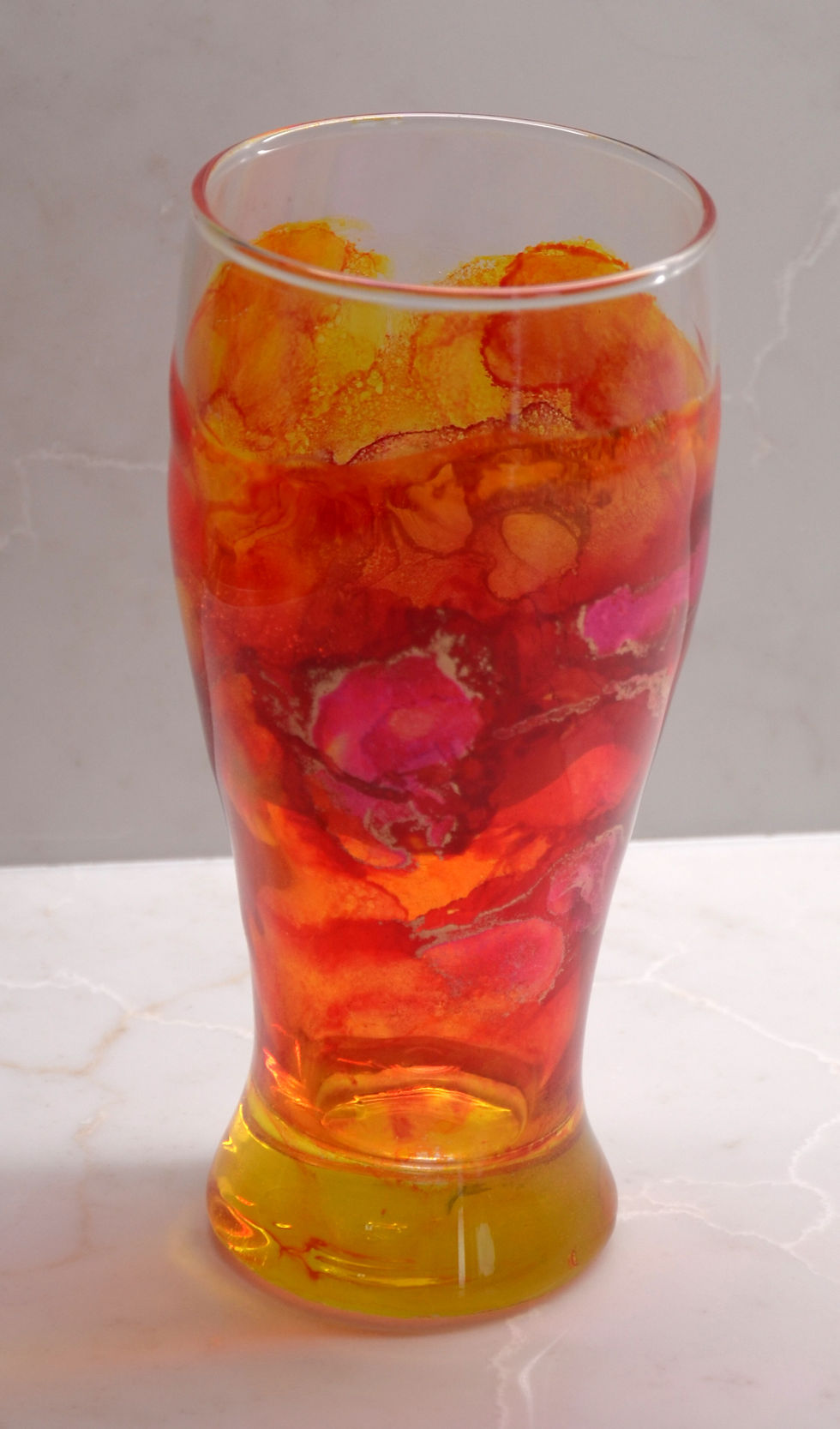 orange pilsner glass hand painted with alcohol ink