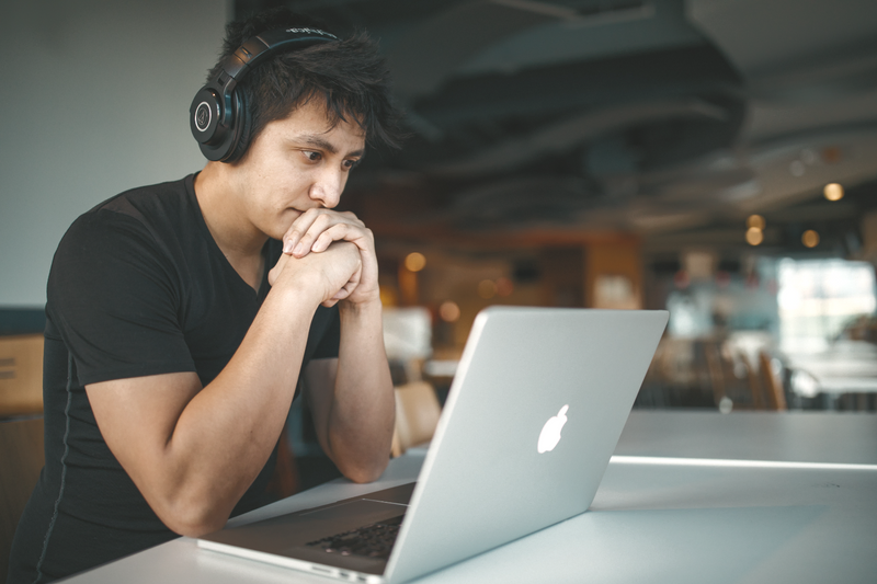 a person is typing on a laptop with the shift key visible