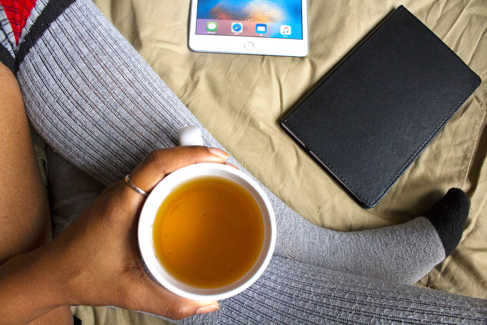 black-woman-in-bed-with-tea-createherstock