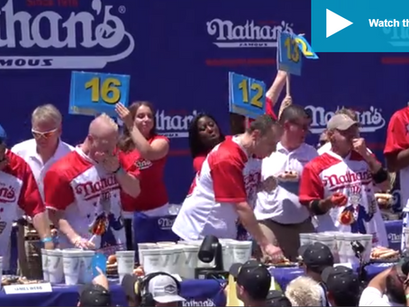 Joey Chestnut (on crutches) TAKES DOWN animal rights protester midway through Nathan's Hot Dog Eatin