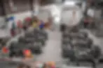 Overhead view of Truckrite's workshop showing two tanker trailers under repair, with technicians in yellow and blue uniforms