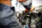 An image of a Truckrite employee connecting new wiring inside a light commerical truck dash
