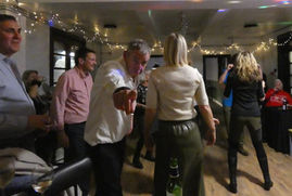 A group of people talking and dancing at an event