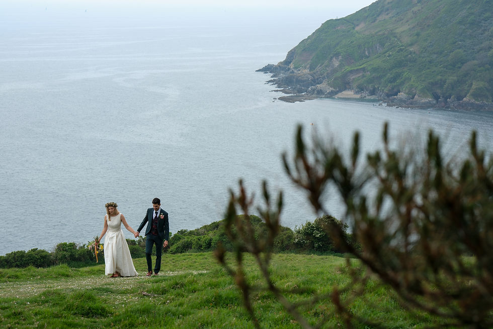 bride and groom on cliff in cornwall
