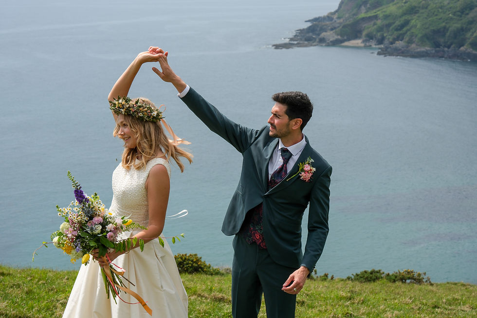 bride and groom on cliff top in cornwall
