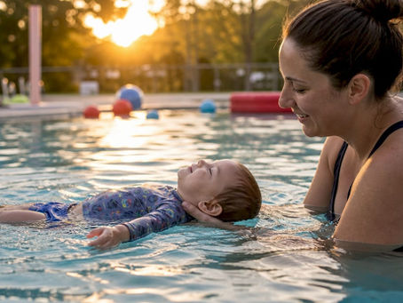 Parent supporting toddler self-rescue float in pool