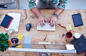 Man working at a Clutter Desk
