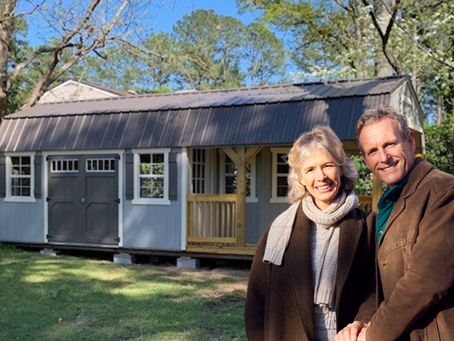 Happy couple with newly delivered backyard shed