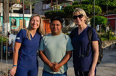 Two doctors smiling with a patient