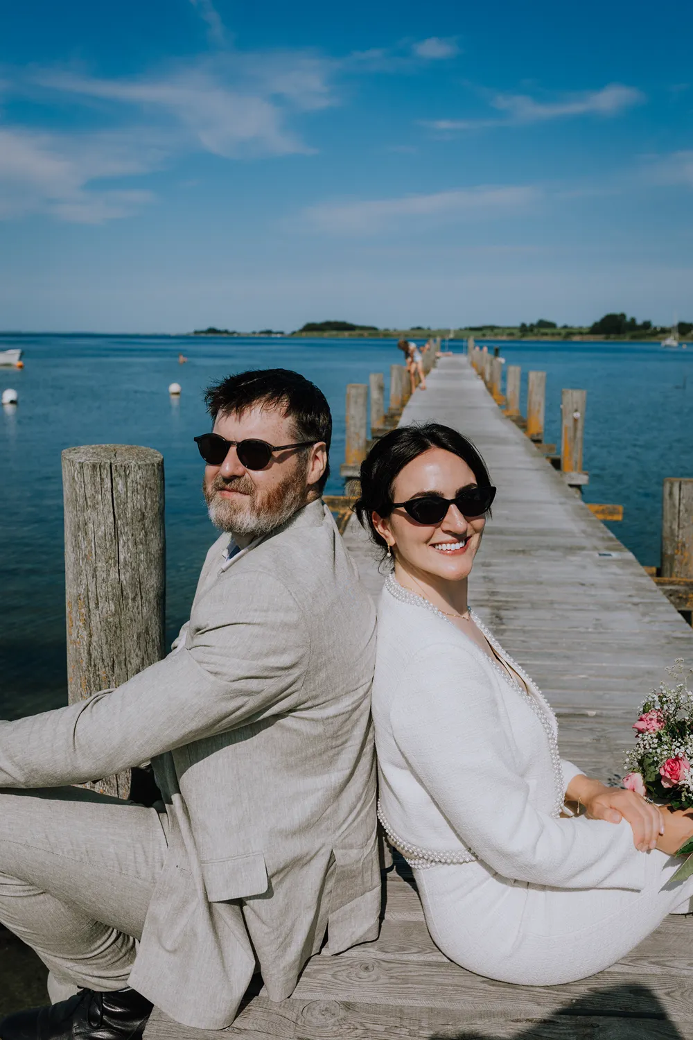 Documentary Ærø elopement portraits in colourful streets and under a soft wedding veil.
