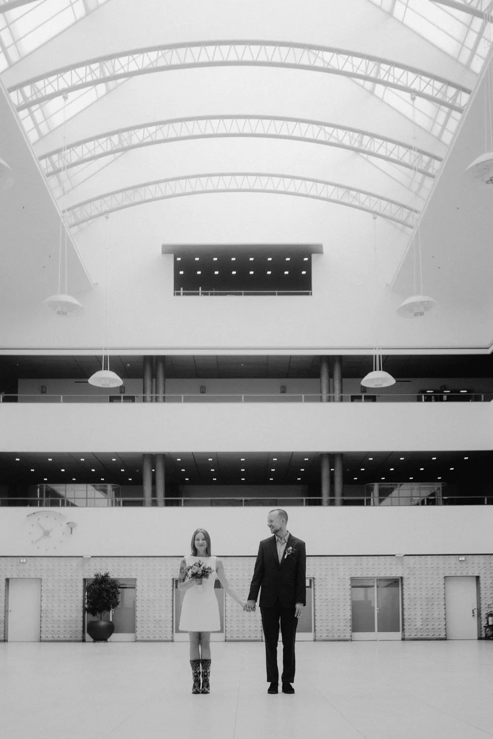 Minimalist indoor wedding portraits inside Odense City Hall.