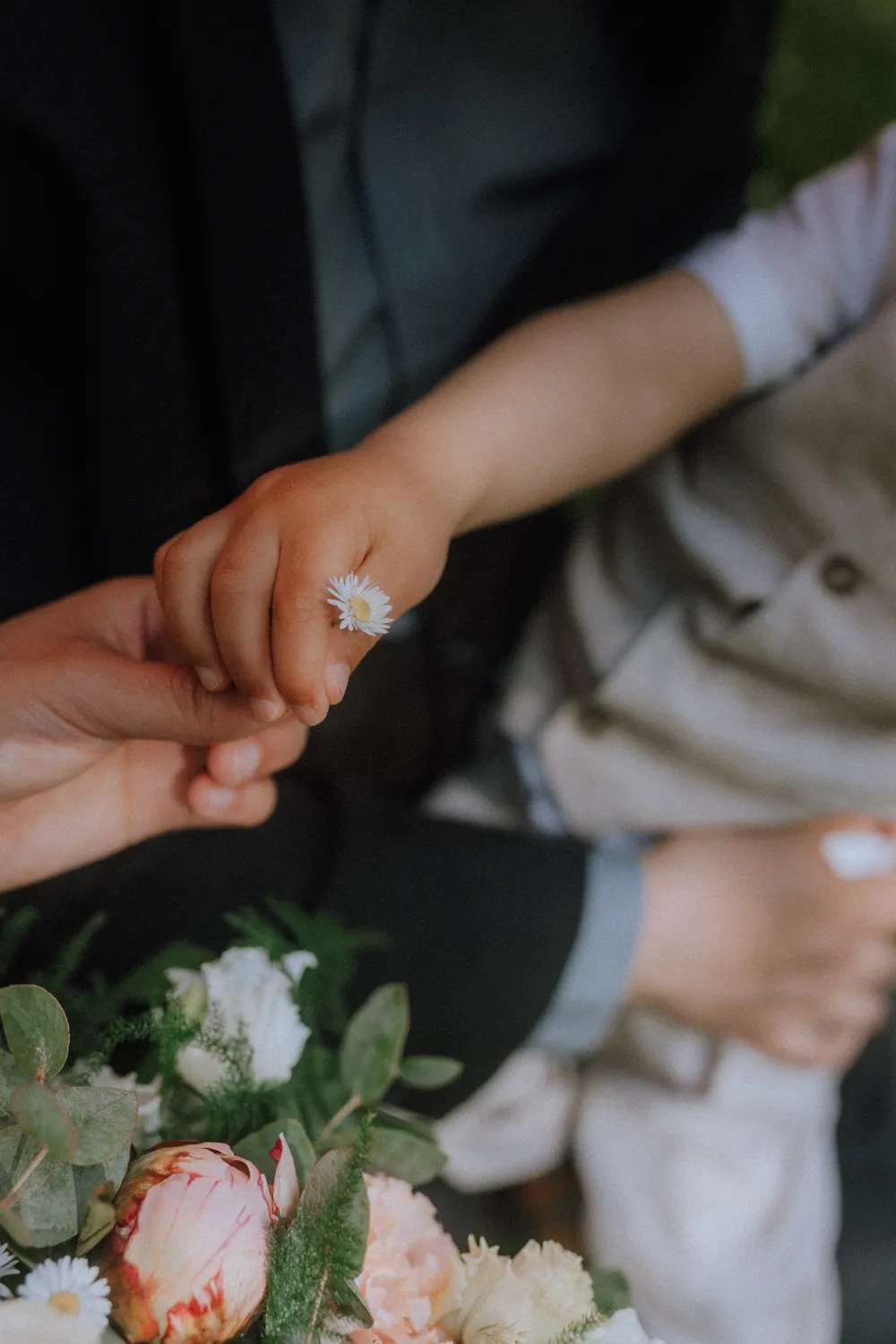 Child holding hands with parents after an Odense elopement