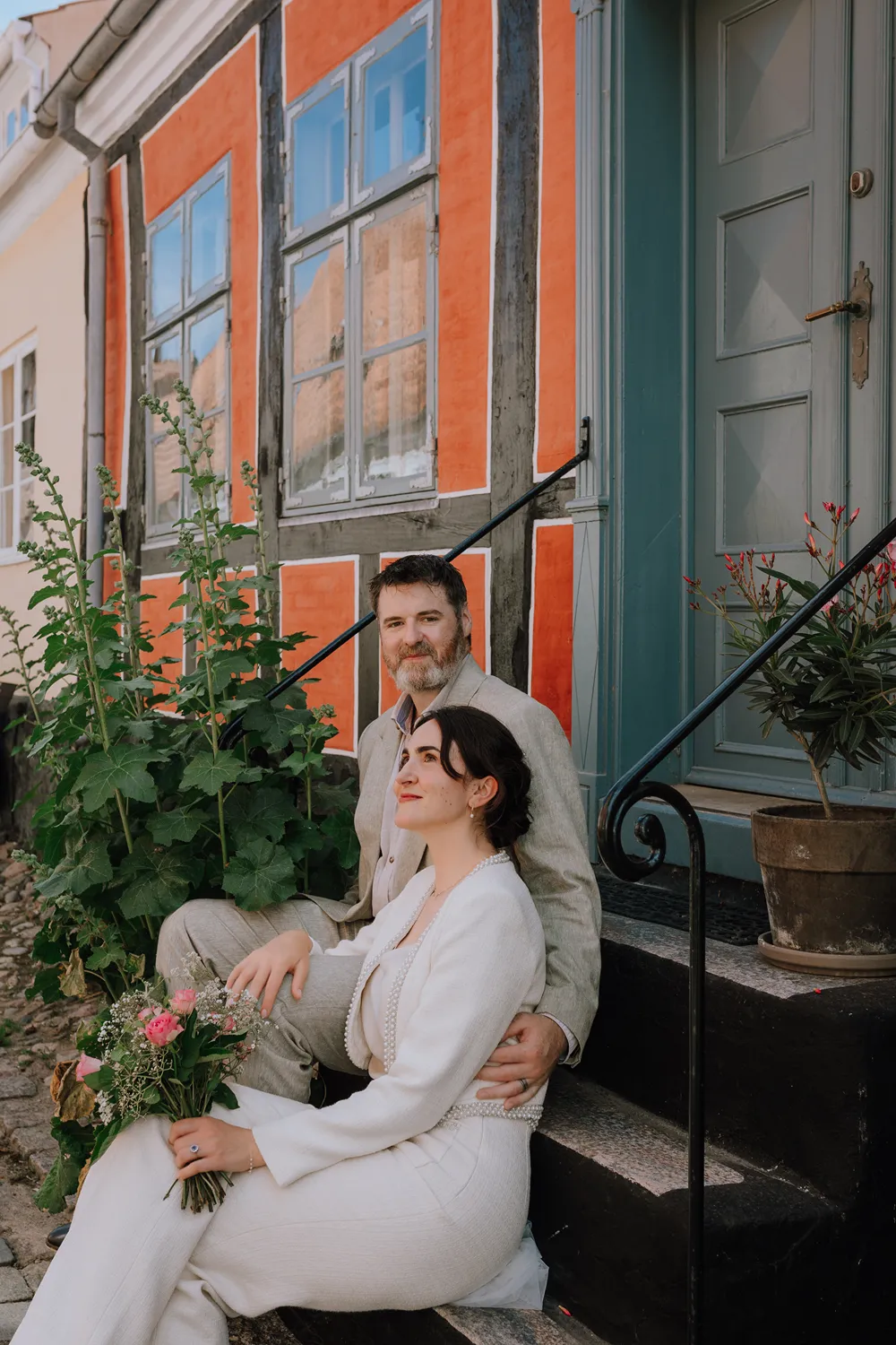 Quiet couple portrait in the grass after a small and emotional Ærø wedding ceremony.
