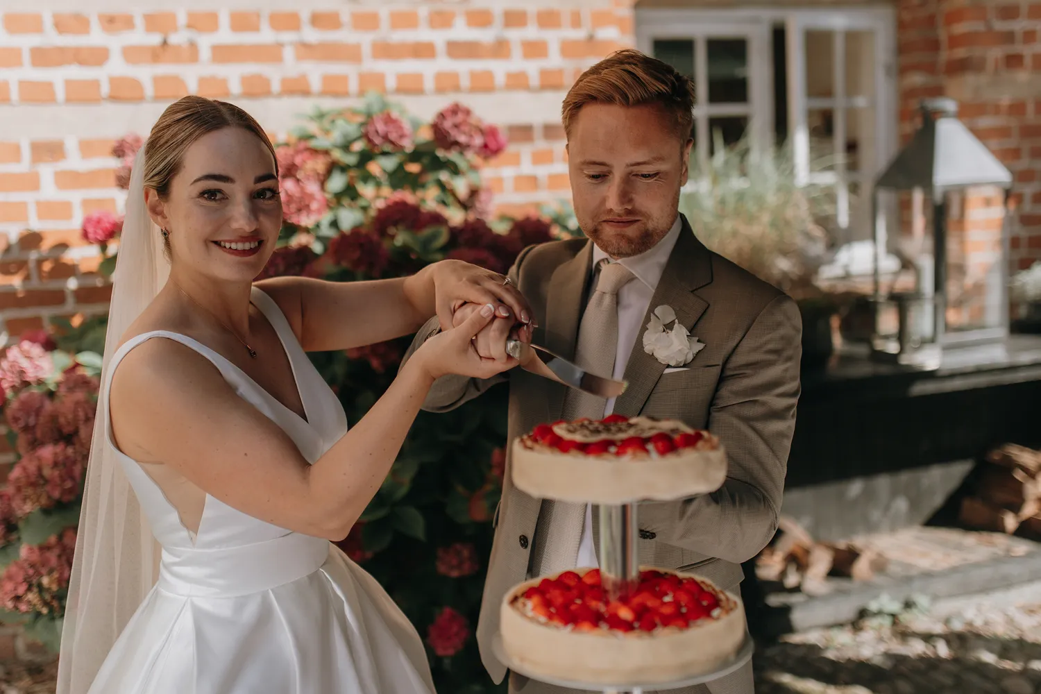 Cake cutting during luxury wedding reception at Holckenhavn Slot