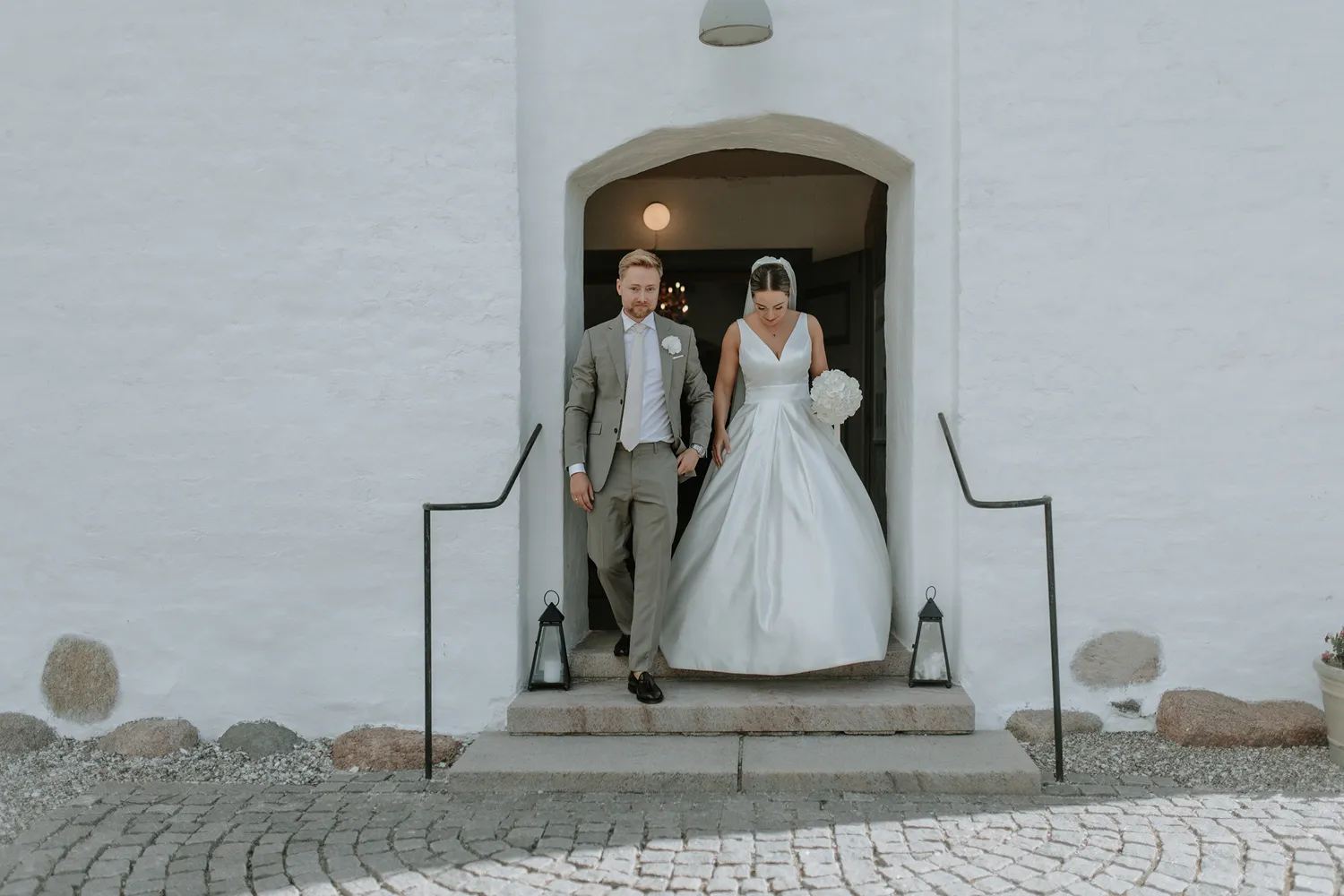 Joyful confetti moment outside church during Holckenhavn wedding