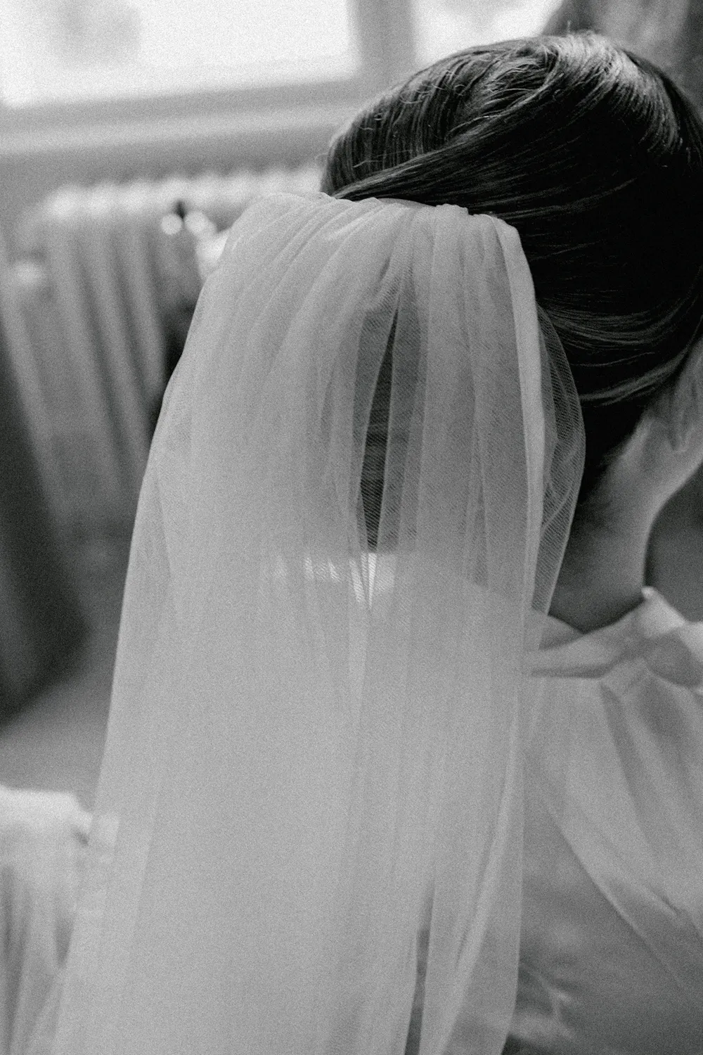 Bride putting on earrings and veil during luxury castle wedding preparations