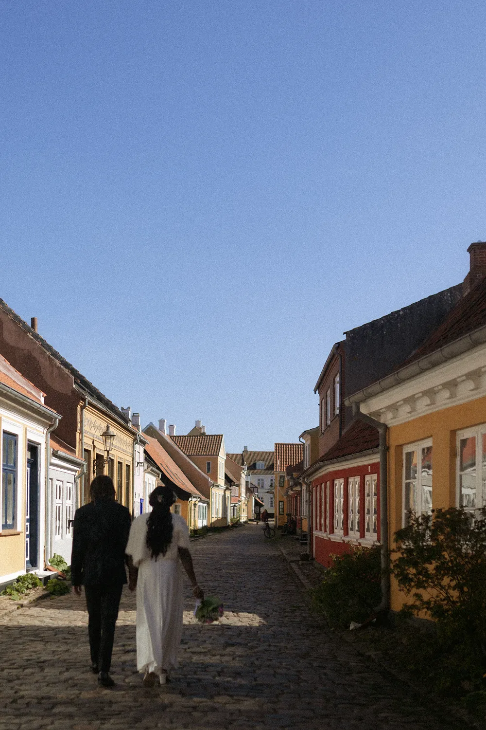 Groom embracing bride during intimate destination wedding in Denmark.