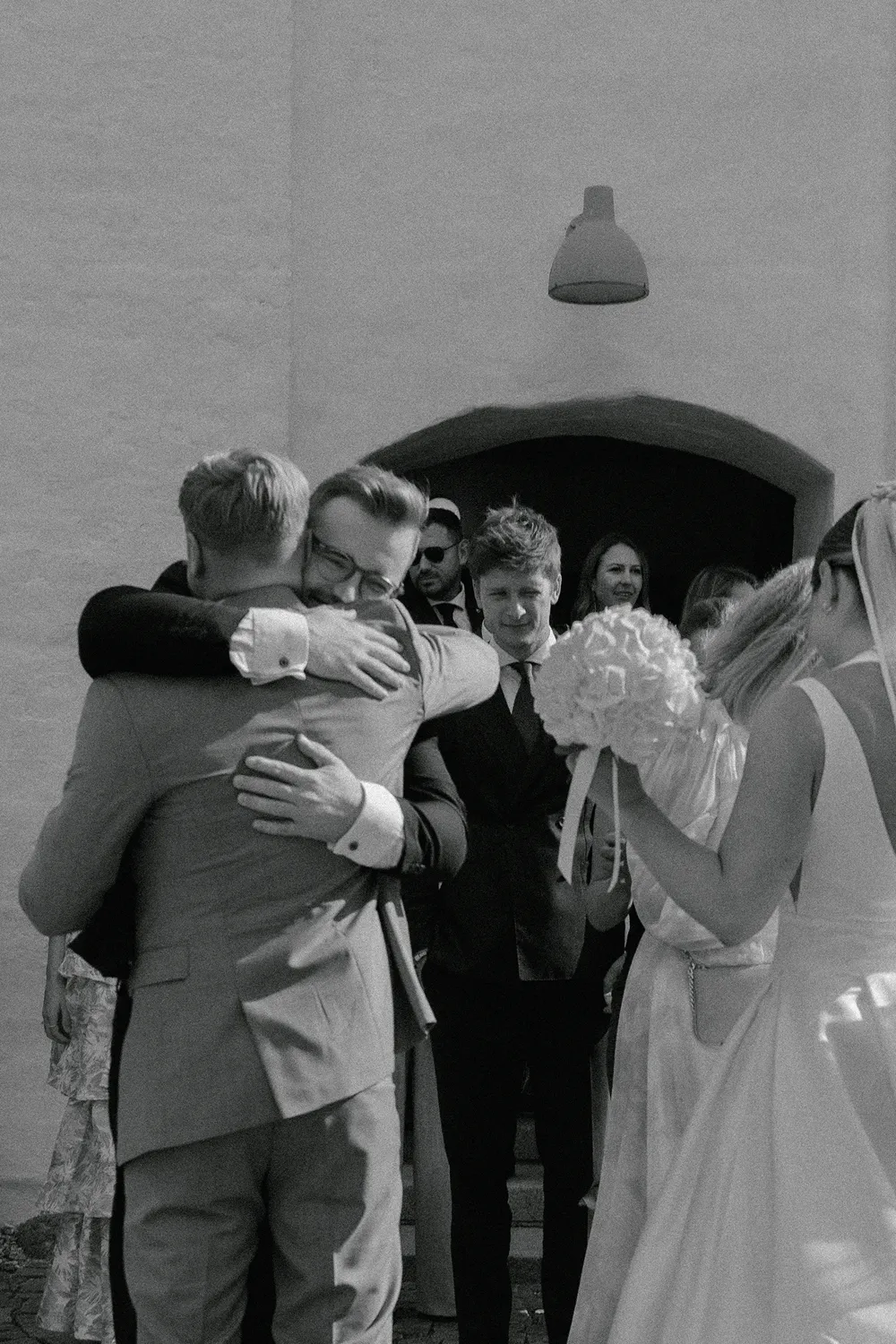 Emotional hugs after church ceremony at luxury Denmark wedding