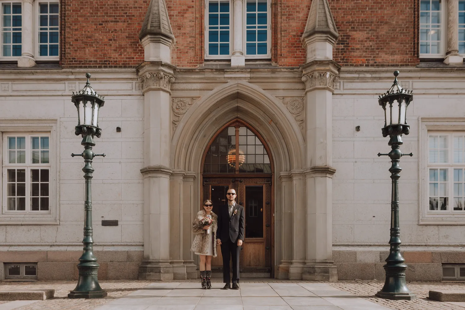 Bride and groom outside Odense City Hall after intimate elopement.