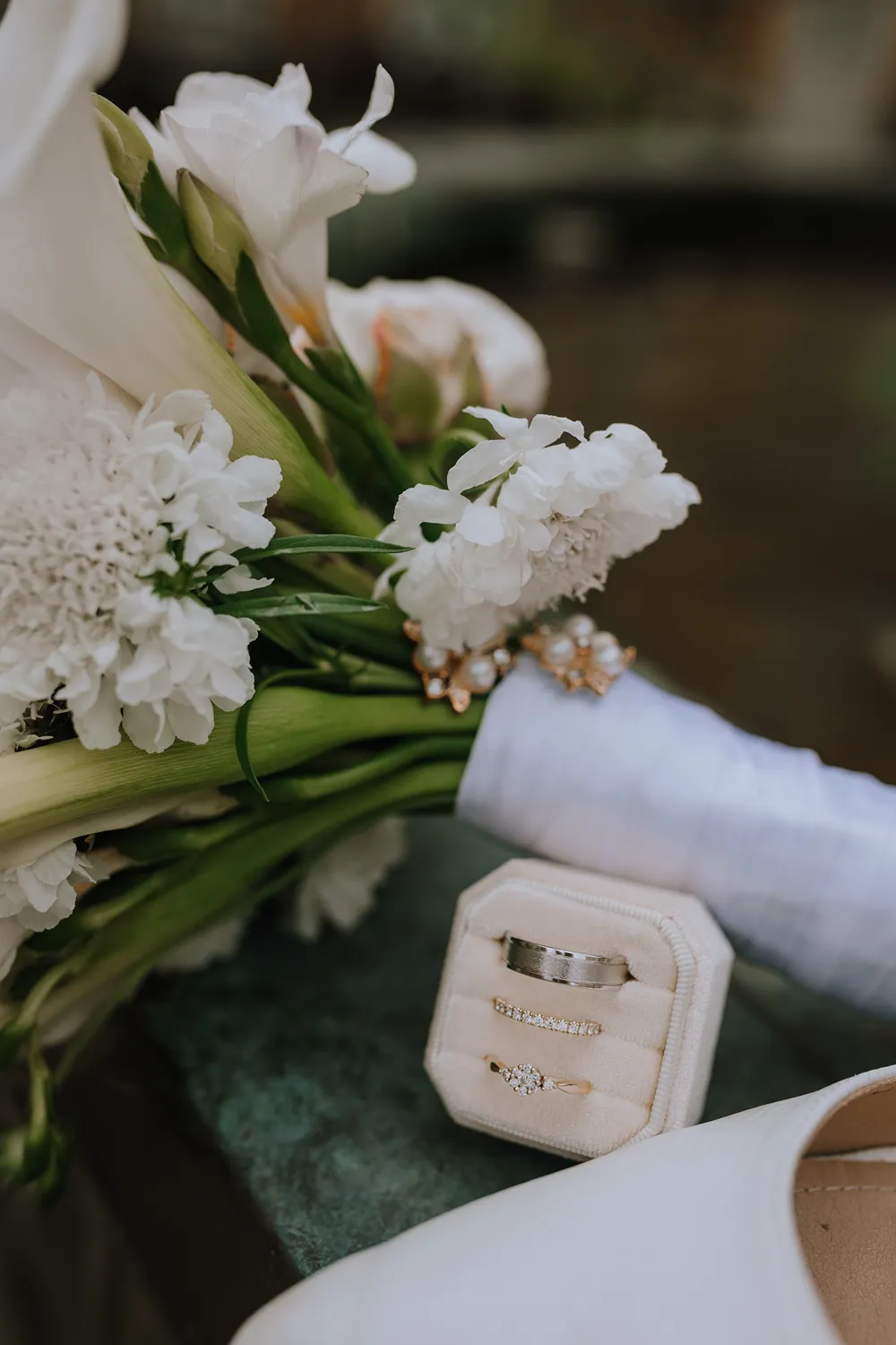 Wedding bouquet and rings photographed by Juniper Picture Lab