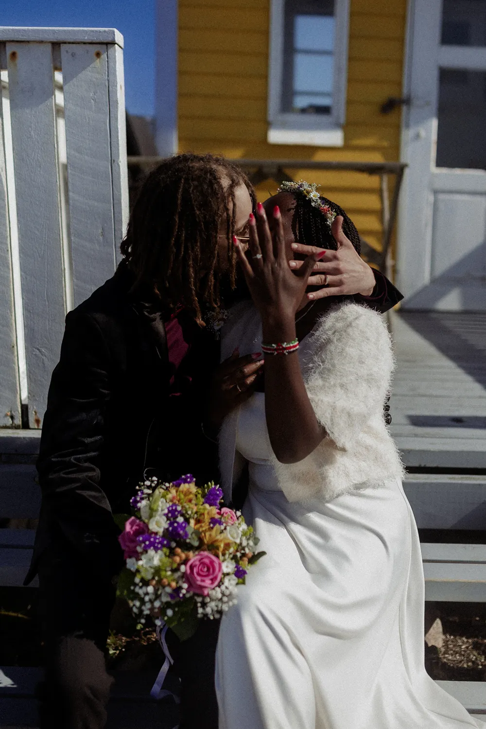 Intimate couple portrait beside historic yellow house in Ærøskøbing.