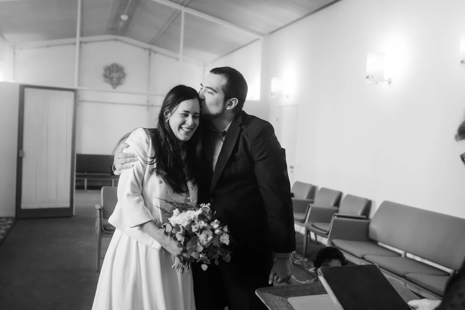 Bride and groom standing in the wedding room at Odense City Hall.