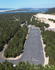 An aerial view of OHV Staging Area, a paved road with forests leading to the oregon dunes