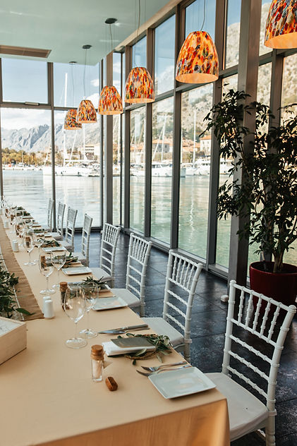 decorated-wedding-reception-venue-with-view-sea-through-windows.jpg